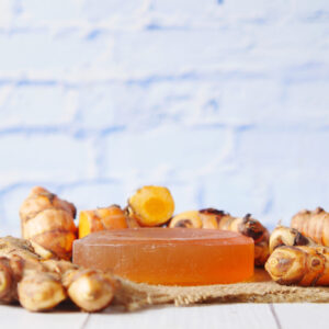 turmeric root and herbal soap on table