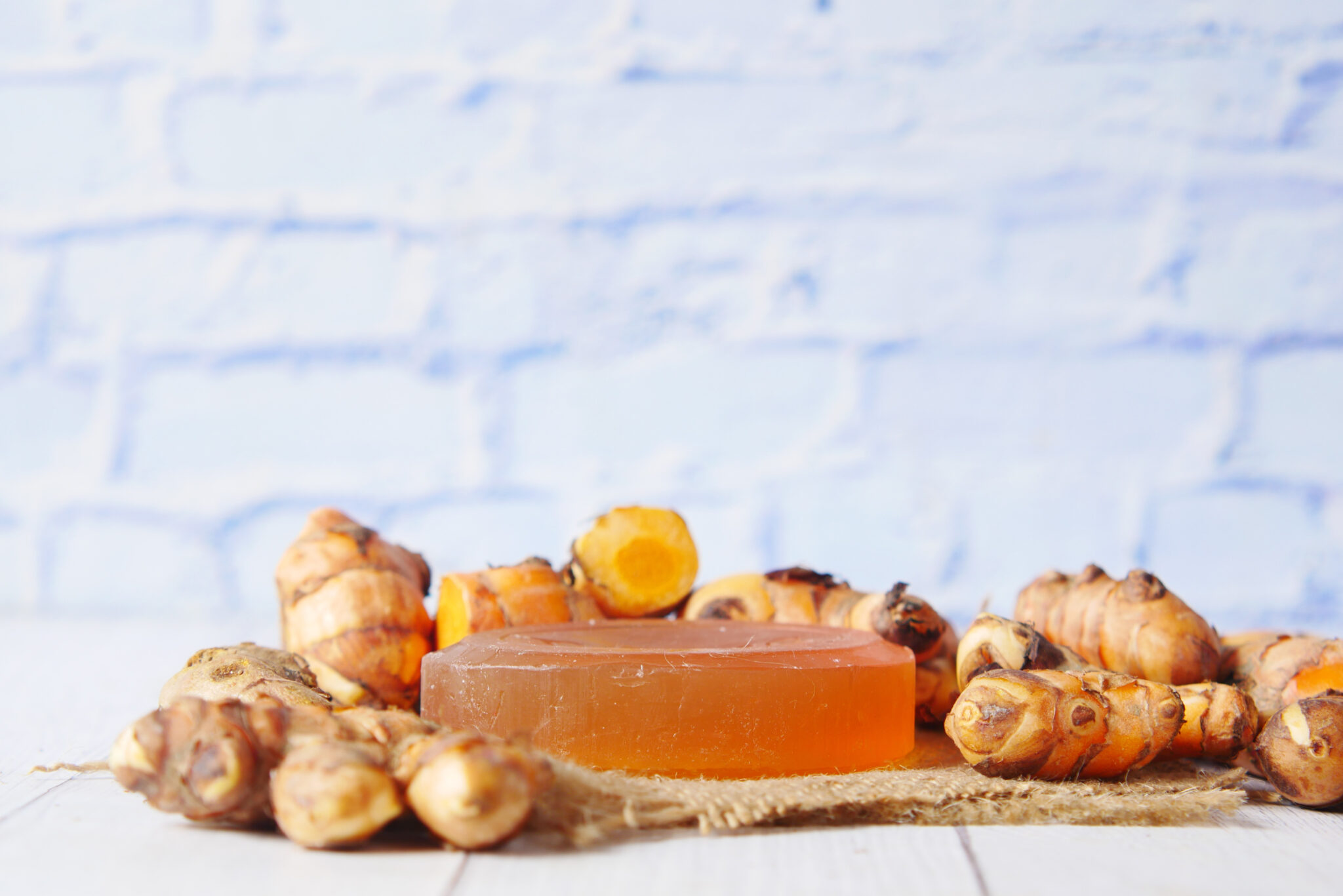 turmeric root and herbal soap on table